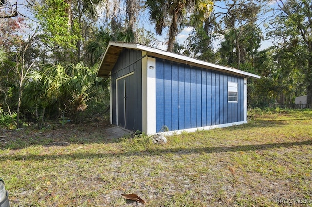 view of outbuilding featuring a yard