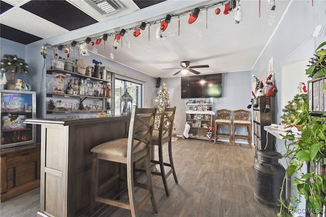 bar featuring ceiling fan, beverage cooler, and hardwood / wood-style flooring