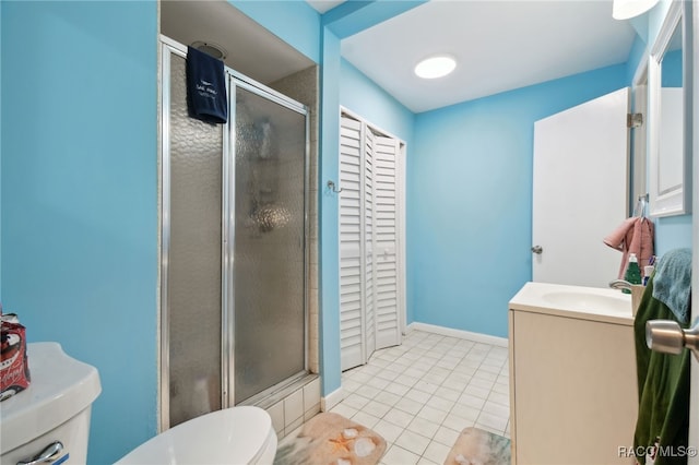 bathroom with tile patterned floors, vanity, toilet, and an enclosed shower