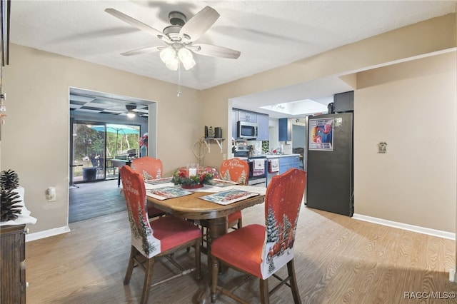 dining space with ceiling fan and hardwood / wood-style flooring