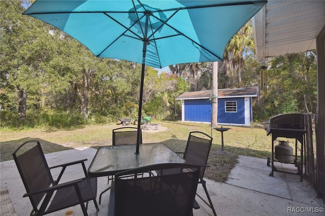 view of patio / terrace with grilling area and a shed