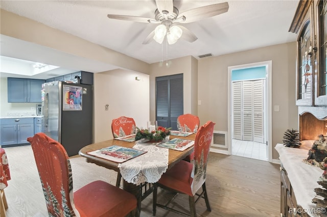 dining area featuring light wood-type flooring and ceiling fan