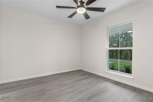 4911 S Skyblue Dr, Inverness, FL 34452 - unfurnished room with ceiling fan, wood finished floors, a wealth of natural light, and baseboards