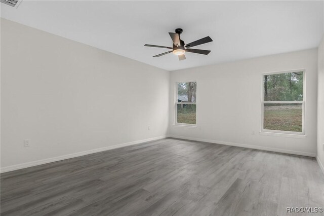 4911 S Skyblue Dr, Inverness, FL 34452 - spare room with ceiling fan, wood finished floors, visible vents, and baseboards