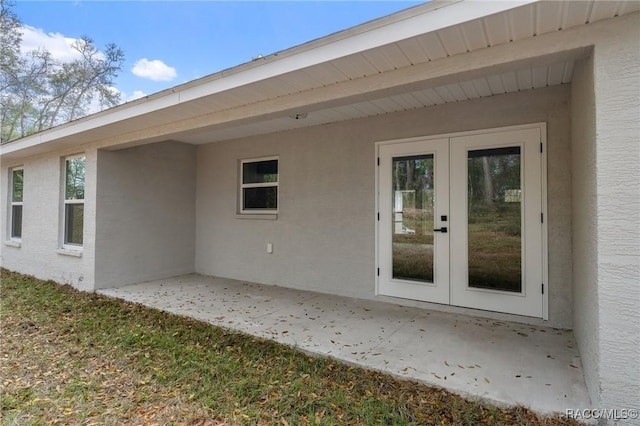 4911 S Skyblue Dr, Inverness, FL 34452 - back of house featuring french doors, a patio area, and stucco siding