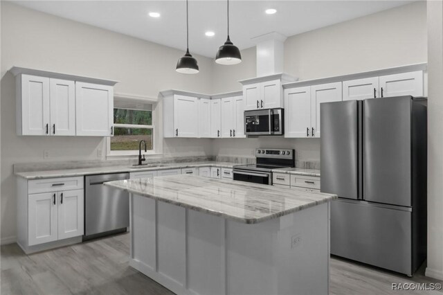 4911 S Skyblue Dr, Inverness, FL 34452 - kitchen featuring a sink, stainless steel appliances, a kitchen island, and white cabinets