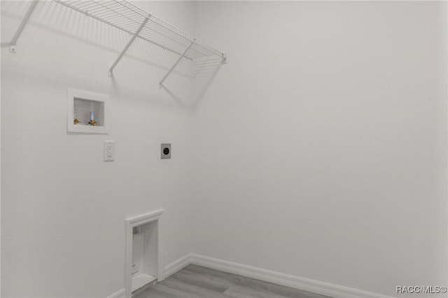 4911 S Skyblue Dr, Inverness, FL 34452 - washroom with laundry area, light wood finished floors, baseboards, hookup for an electric dryer, and washer hookup