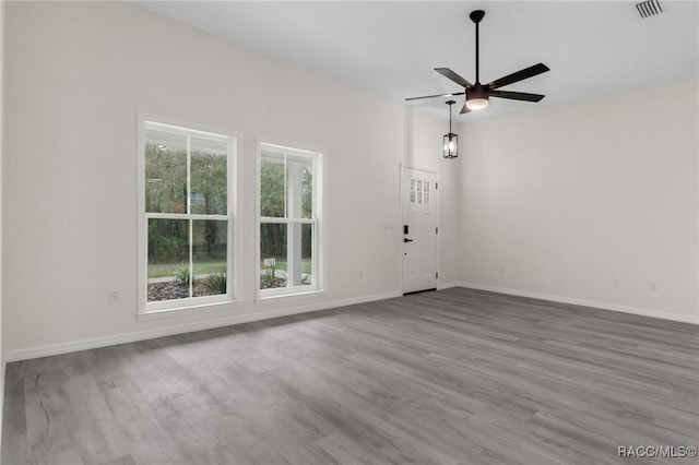 4911 S Skyblue Dr, Inverness, FL 34452 - unfurnished living room featuring ceiling fan, wood finished floors, visible vents, and baseboards