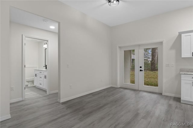 4911 S Skyblue Dr, Inverness, FL 34452 - unfurnished dining area with light wood-style floors, french doors, and baseboards