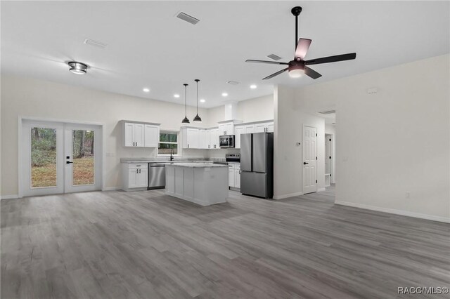 4911 S Skyblue Dr, Inverness, FL 34452 - kitchen with a center island, white cabinetry, stainless steel appliances, and open floor plan