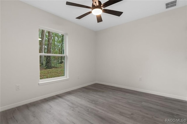 4911 S Skyblue Dr, Inverness, FL 34452 - unfurnished room with dark wood-type flooring, a ceiling fan, visible vents, and baseboards