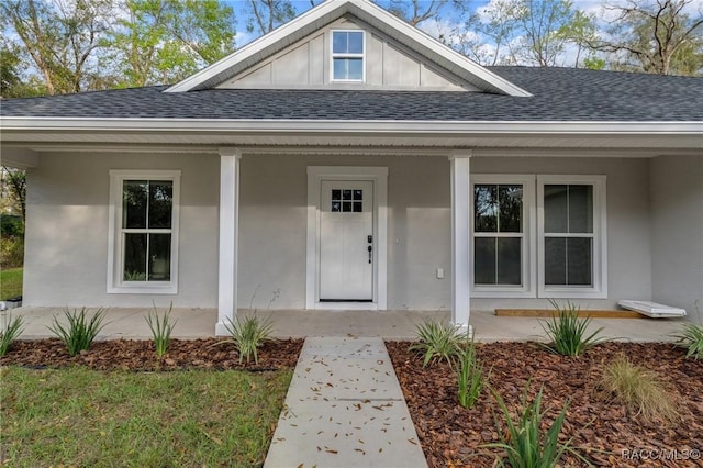 4911 S Skyblue Dr, Inverness, FL 34452 - doorway to property with covered porch, roof with shingles, and stucco siding