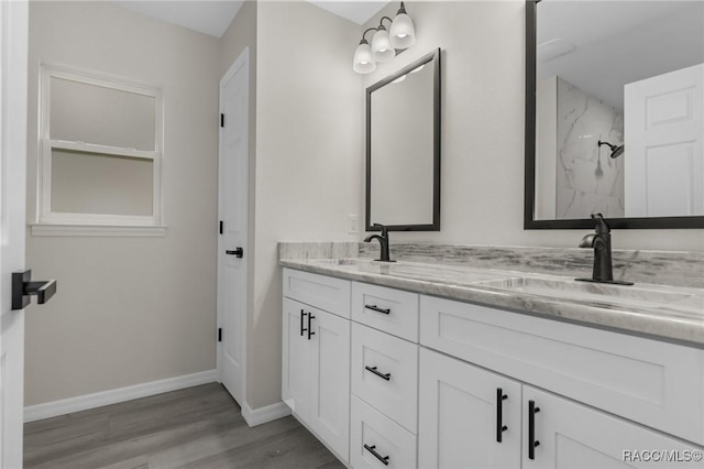 4911 S Skyblue Dr, Inverness, FL 34452 - bathroom featuring double vanity, wood finished floors, a sink, and a marble finish shower