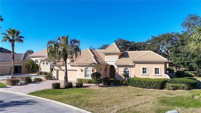 view of front facade with a front yard and a garage