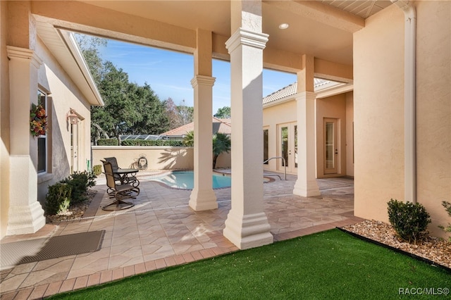 view of patio / terrace with french doors and a fenced in pool