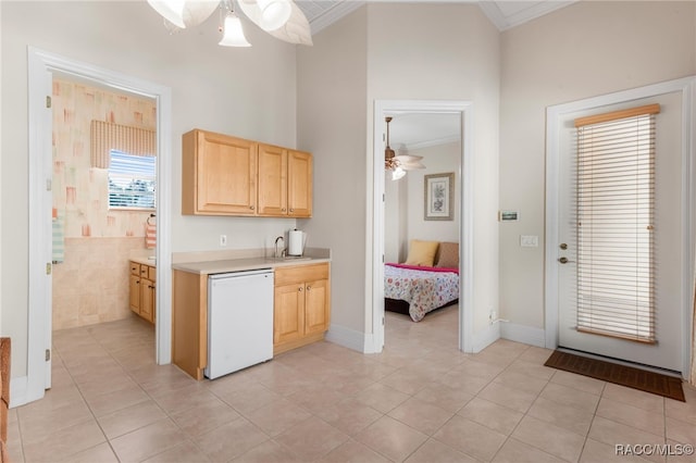 kitchen with crown molding, light brown cabinetry, and white dishwasher