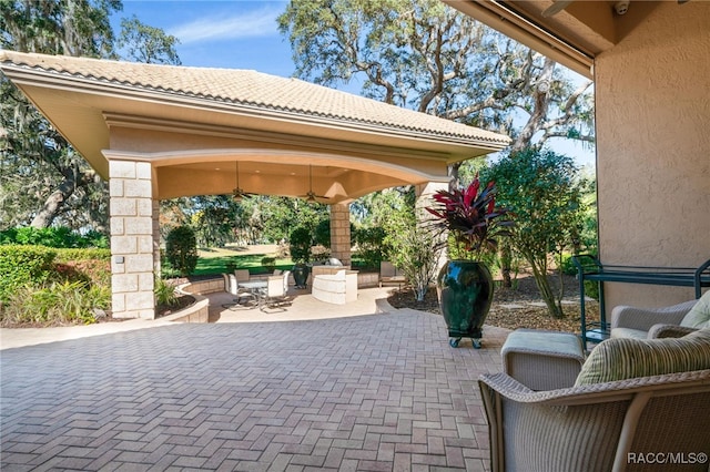 view of patio / terrace featuring ceiling fan