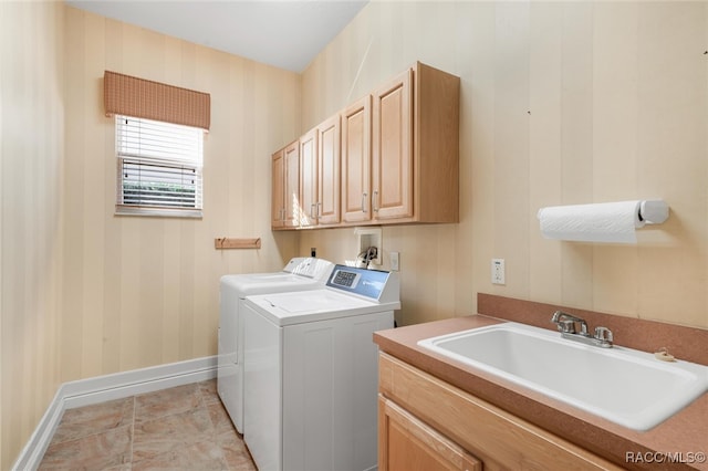 laundry room featuring cabinets, separate washer and dryer, light tile patterned flooring, and sink