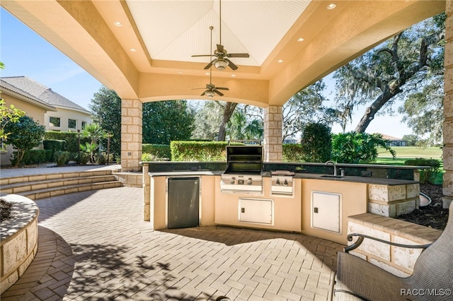 view of patio / terrace featuring ceiling fan, sink, grilling area, and an outdoor kitchen