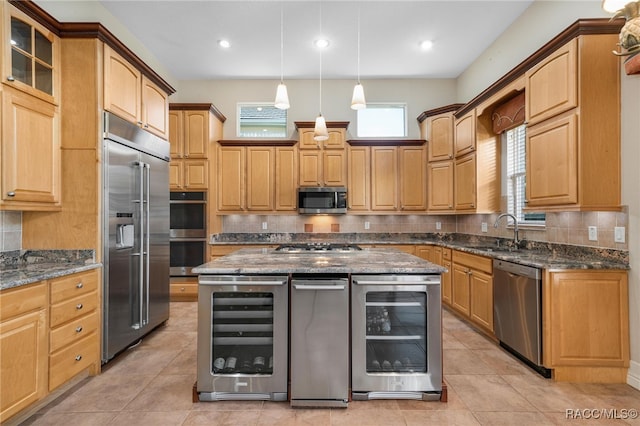 kitchen featuring beverage cooler, a kitchen island, and appliances with stainless steel finishes