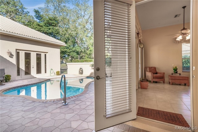 view of pool with french doors, a patio, and ceiling fan