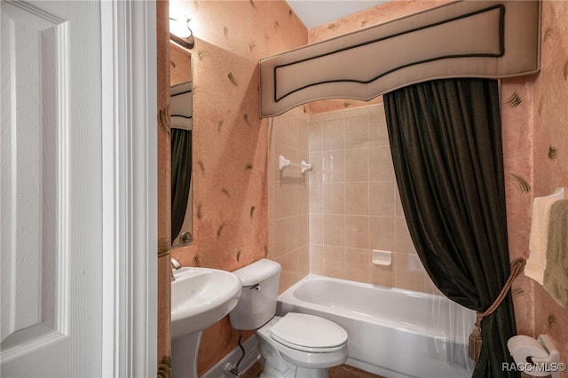 bathroom with toilet and shower / bath combo with shower curtain