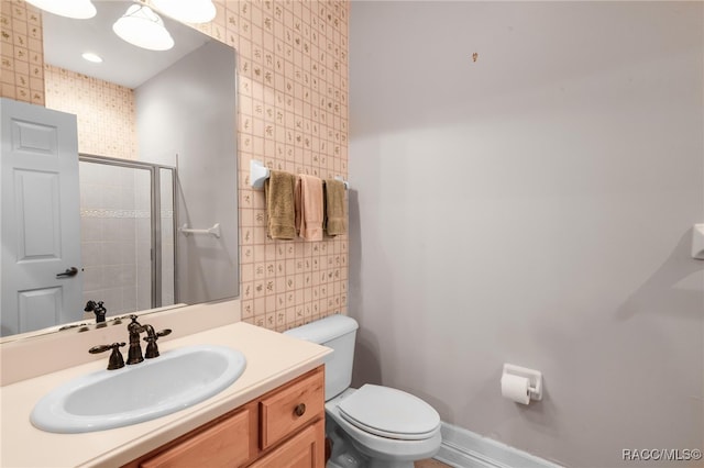 bathroom with vanity, an enclosed shower, and toilet