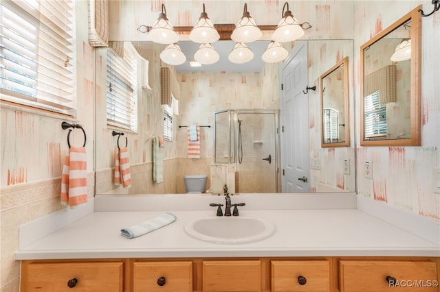 bathroom featuring vanity, toilet, and walk in shower