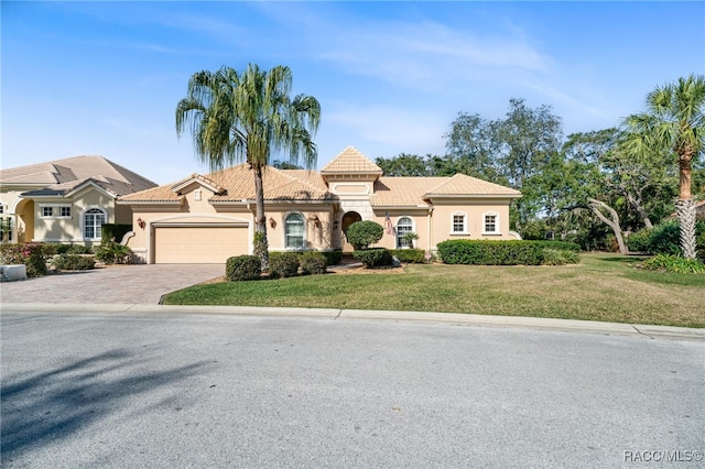 view of front of property with a front yard and a garage