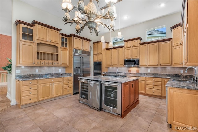 kitchen with sink, a center island, hanging light fixtures, stainless steel appliances, and wine cooler