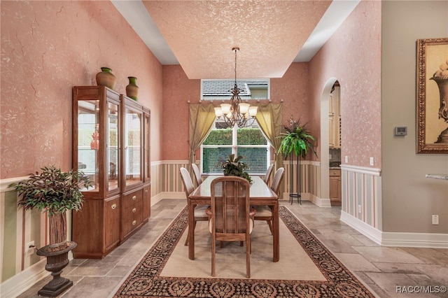 dining room featuring a textured ceiling and an inviting chandelier