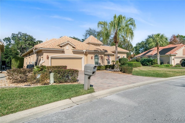 view of front of home featuring a garage and a front yard