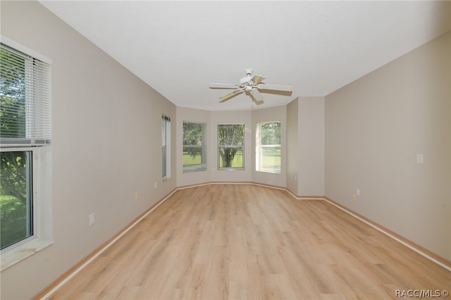 spare room featuring light wood-type flooring and ceiling fan