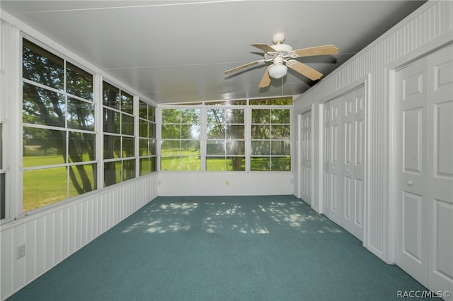 unfurnished sunroom featuring plenty of natural light, lofted ceiling, and ceiling fan