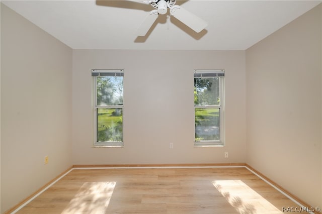 unfurnished room featuring light hardwood / wood-style floors, plenty of natural light, and ceiling fan