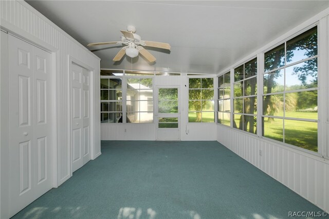 unfurnished sunroom featuring plenty of natural light and ceiling fan