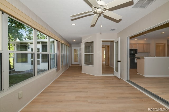 unfurnished sunroom with french doors and ceiling fan