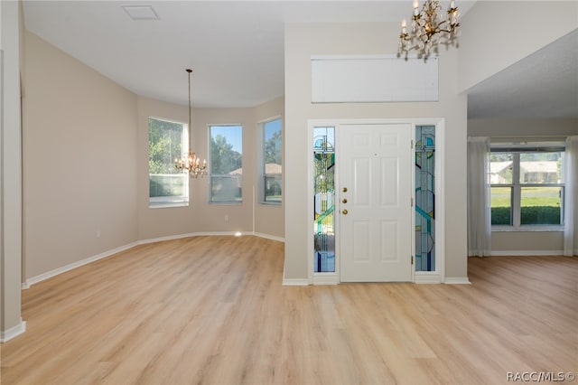 foyer entrance featuring a chandelier and light wood-type flooring