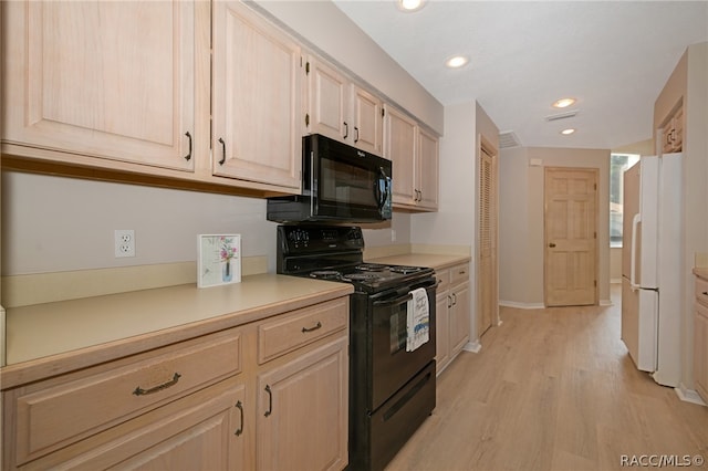 kitchen featuring light brown cabinetry, black appliances, and light wood-type flooring