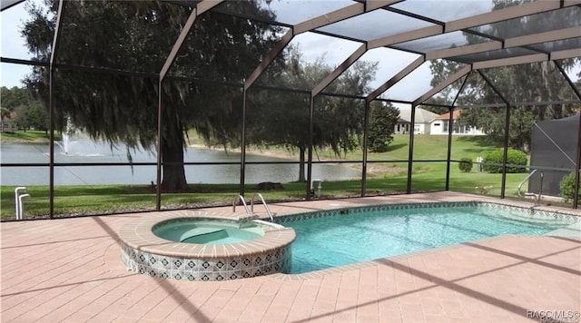 view of pool with a lawn, a lanai, a patio area, an in ground hot tub, and a water view