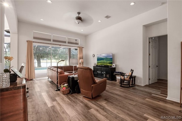 living area with hardwood / wood-style flooring and ceiling fan