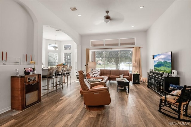 living room with ceiling fan and hardwood / wood-style flooring