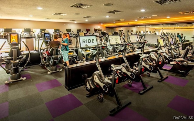 exercise room featuring a textured ceiling