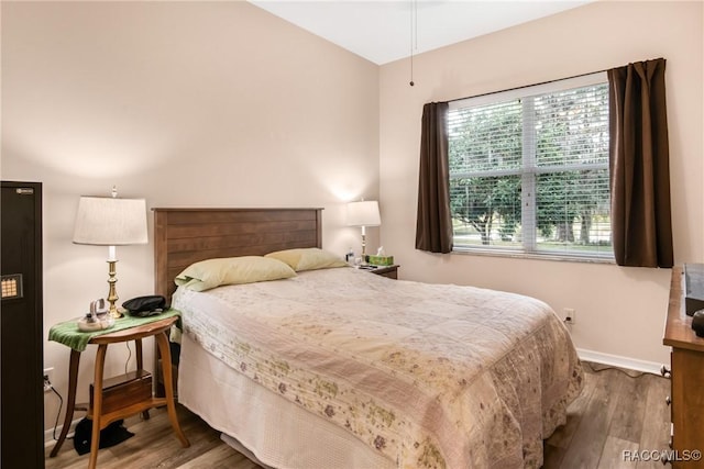 bedroom with hardwood / wood-style floors