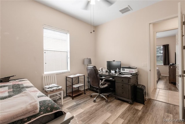 bedroom with light hardwood / wood-style flooring and ceiling fan