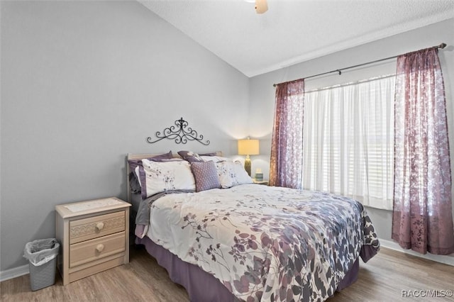 158 N Skyflower Pt, Lecanto, FL 34461 - bedroom featuring light wood-type flooring, vaulted ceiling, baseboards, and ceiling fan