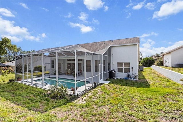 158 N Skyflower Pt, Lecanto, FL 34461 - rear view of house featuring an outdoor pool, stucco siding, a lawn, glass enclosure, and a patio