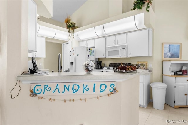 158 N Skyflower Pt, Lecanto, FL 34461 - kitchen with white appliances, light tile patterned flooring, light countertops, and white cabinetry