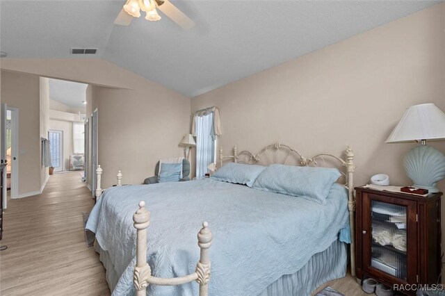 158 N Skyflower Pt, Lecanto, FL 34461 - bedroom with lofted ceiling, light wood finished floors, a ceiling fan, and baseboards