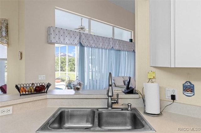 158 N Skyflower Pt, Lecanto, FL 34461 - kitchen featuring a sink, ceiling fan, light countertops, and white cabinets